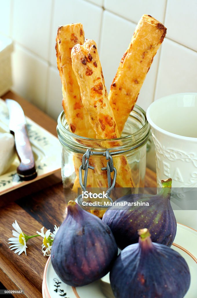 Cheese sticks Still life with figs and cheese sticks. Cheese sticks made of puff pastry and cheese. Appetizer Stock Photo