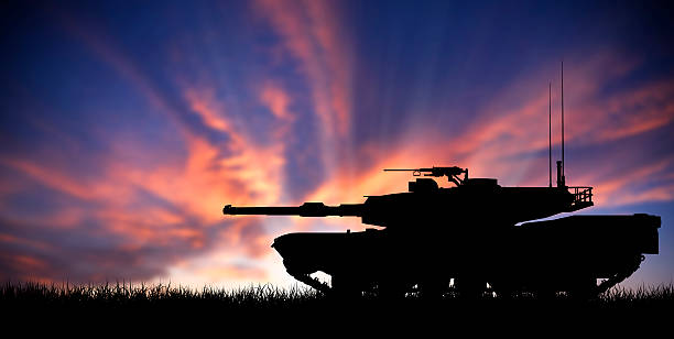 Modern heavy tank at sunset Modern heavy tank isolated in front a sunset armored tank stock pictures, royalty-free photos & images