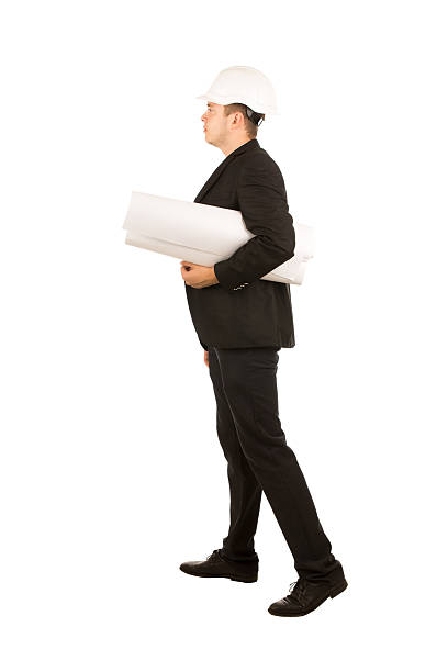 istock Young Male Engineer Side View Carrying Blueprint 500295314