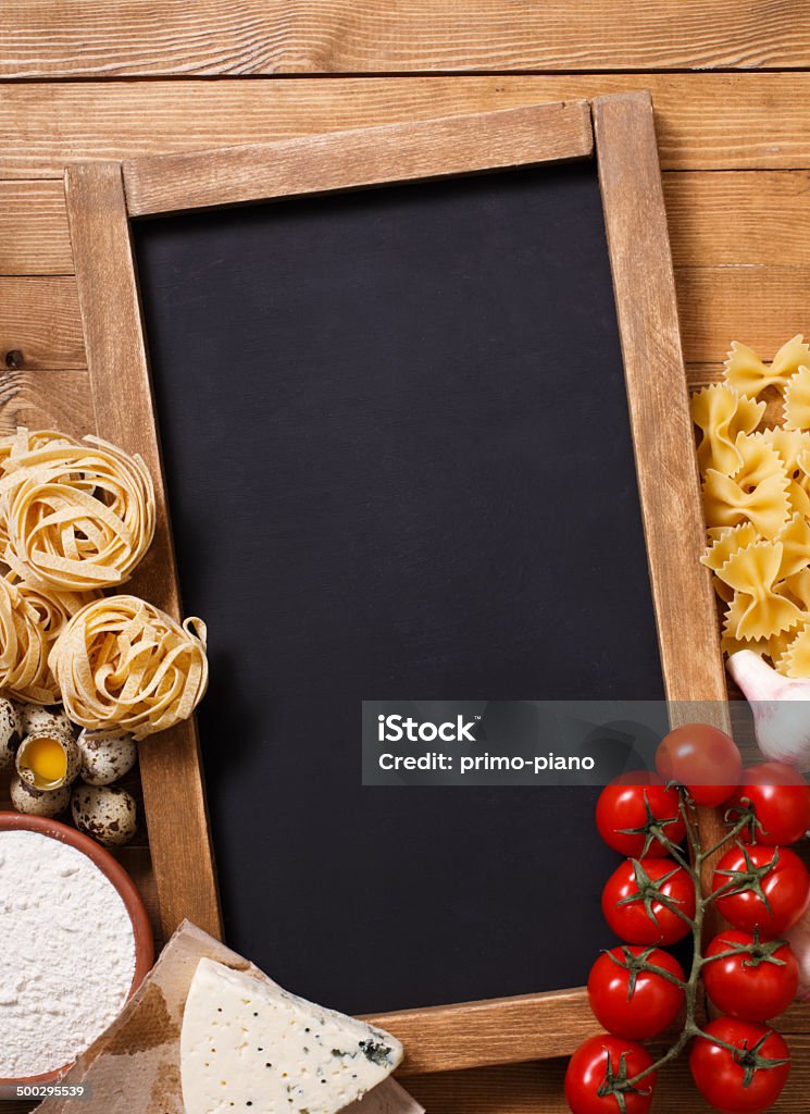 Italian food recipe on rustic wood Overhead view of ingredients for an Italian pasta recipe on rustic wood background Basil Stock Photo