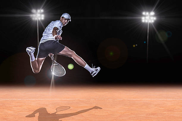 Tennis player reaching for the hard ball