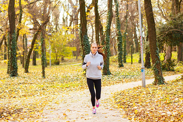 istock Sporty young woman running outside. 500298366