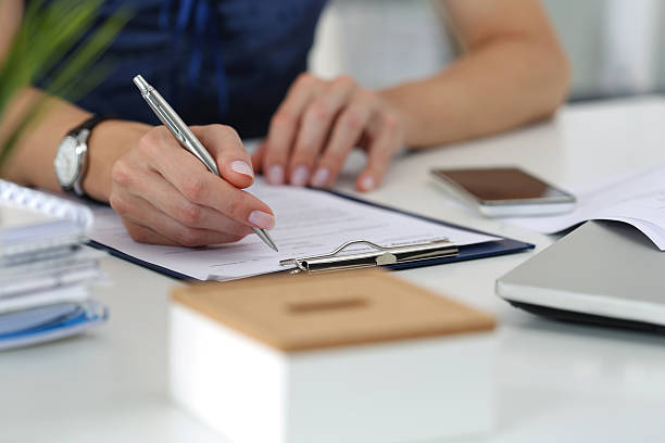 istock Woman writing something sitting at her office 500299038
