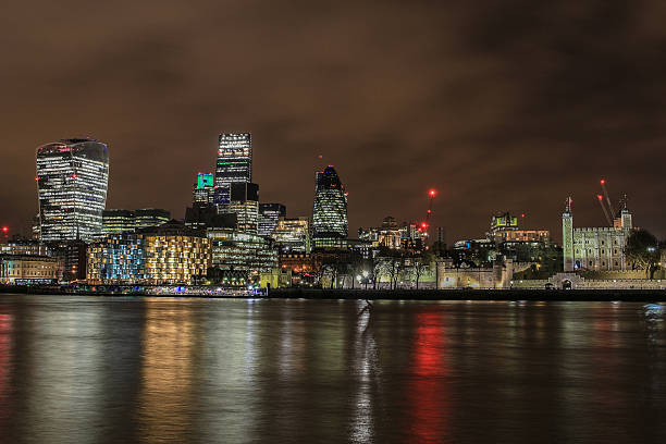 City of London skyline at night City of London skyline at night london gherkin at night stock pictures, royalty-free photos & images