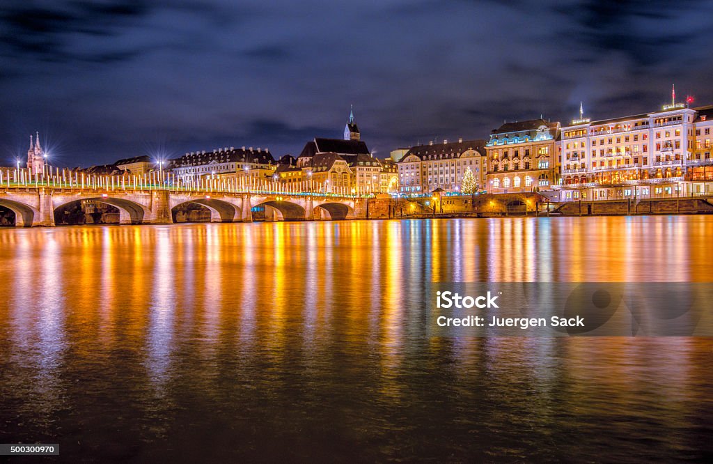 Basel in christmas lights View over the river Rhine on the historic town of Basel, the decorated old stone bridge (Mittlere Brücke (Middle or Central Bridge)) illuminated with christmas lights. Basel - Switzerland Stock Photo