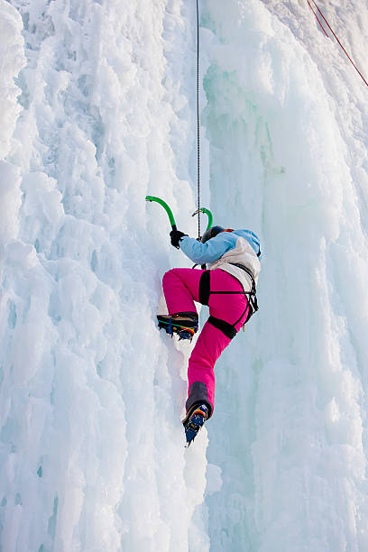 istock Woman climbing frozen waterfall 500301214