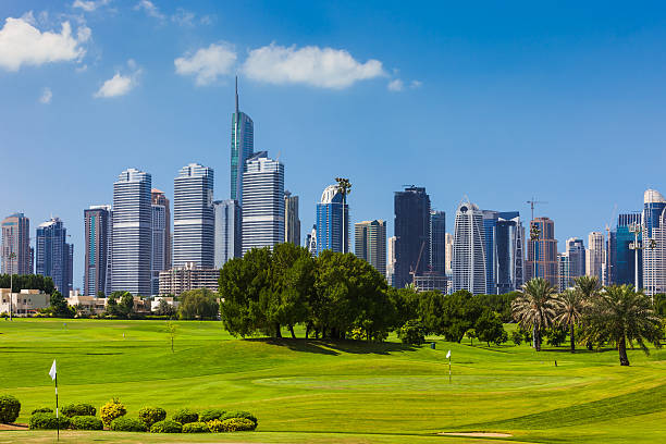 Dubai, United Arab Emirates: Golf Fairway In The Foreground; Modern Skyscrapers Of JLT In The Background - Luxury In Arabia stock photo