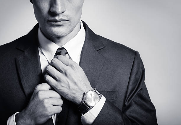 Businessman fixing his suit Businessman fixing his suit. man adjusting tie stock pictures, royalty-free photos & images