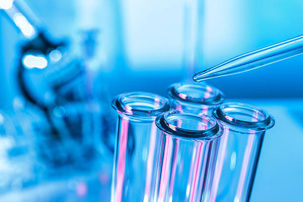 istock Pipette adding fluid to one of several test tubes 500304780