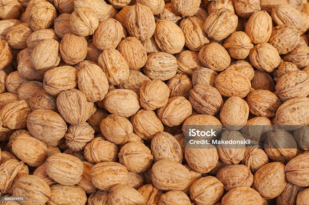 Walnuts Pile of walnuts in shells,walnut background.Lots of walnuts closeup 2015 Stock Photo