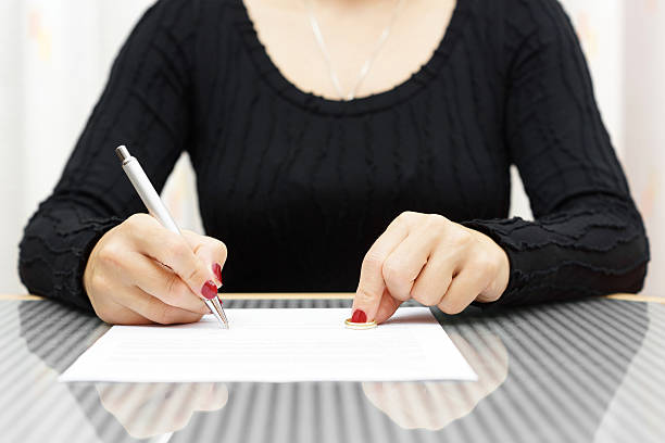 istock woman is signing divorce decree 500305105