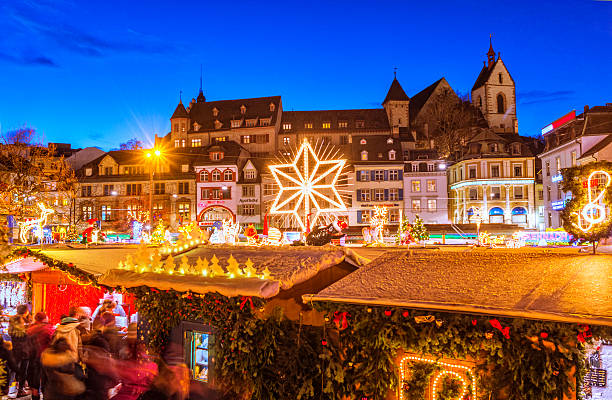 View over the christmas market at the Barfüssplatz in Basel, Switzerland, at dusk.
