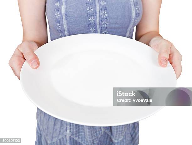 Woman Holds Empty White Plate Stock Photo - Download Image Now - Holding, Empty Plate, One Woman Only