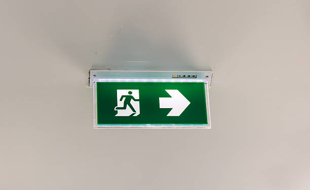 istock green emergency exit sign showing the way to escape 500307845