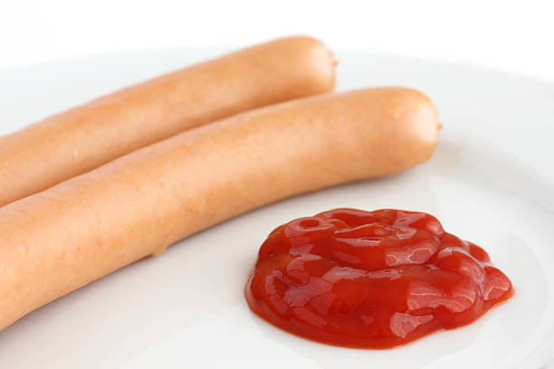 istock Two frankfurter sausages on a plate with ketchup 500309511