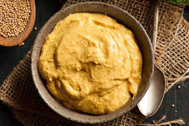 Homemade Spicy Mustard Sauce Homemade Spicy Mustard Sauce on a Background mustard photos stock pictures, royalty-free photos & images