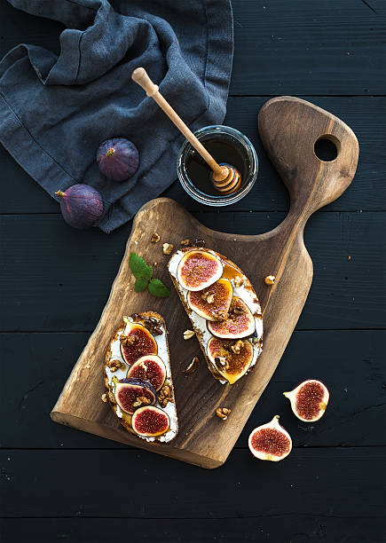 istock Sandwiches with ricotta, fresh figs, walnuts and honey on rustic 500322480