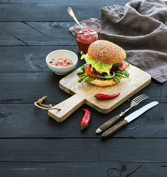 istock Fresh homemade burger on dark serving board with spicy tomato 500322520