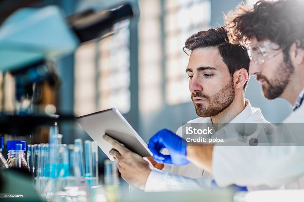 two scientist using digital tablet in laboratory Healthcare And Medicine Stock Photo