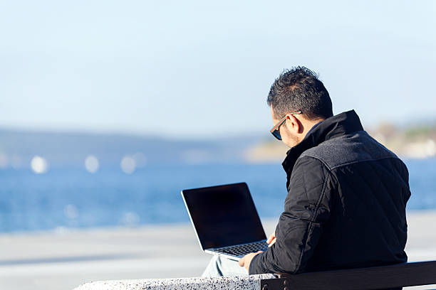 istock Handsome  young man using laptop computer in the outdoor 500324692
