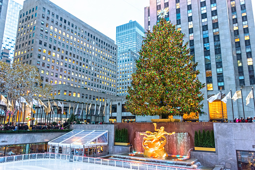 New York, NY, USA - December 7, 2015: The world famous Rockefeller Christmas tree,ice skating rink and surrounding buildings in New York City.