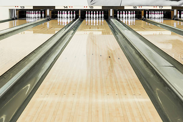 Close up of bowling pins in a row Close up of bowling pins in a row bowling alley stock pictures, royalty-free photos & images