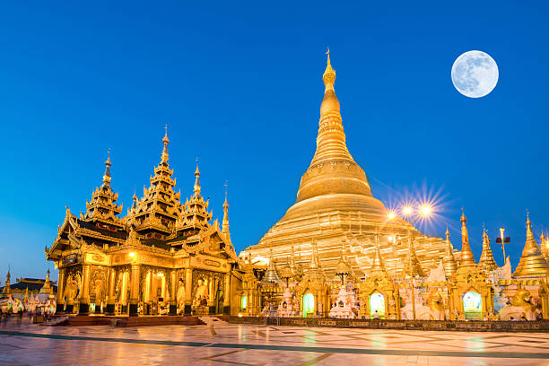 Yangon, Myanmar view of Shwedagon Pagoda with super moon Yangon, Myanmar view of Shwedagon Pagoda with super full moon shwedagon pagoda photos stock pictures, royalty-free photos & images