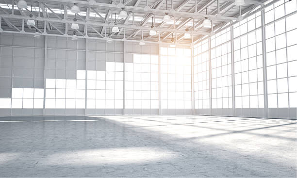 Empty warehouse showroom Vast Empty warehouse for car aor placment of automobile, sun light coming through windows vehicle interior stock pictures, royalty-free photos & images