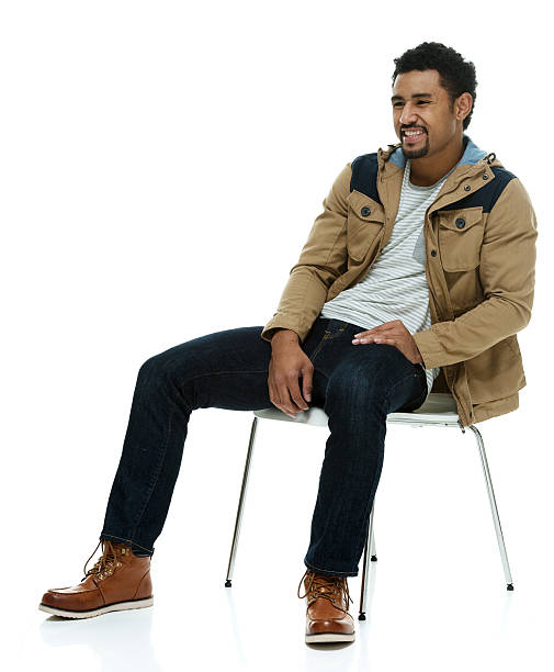 istock Smiling man on chair and looking away 500330652