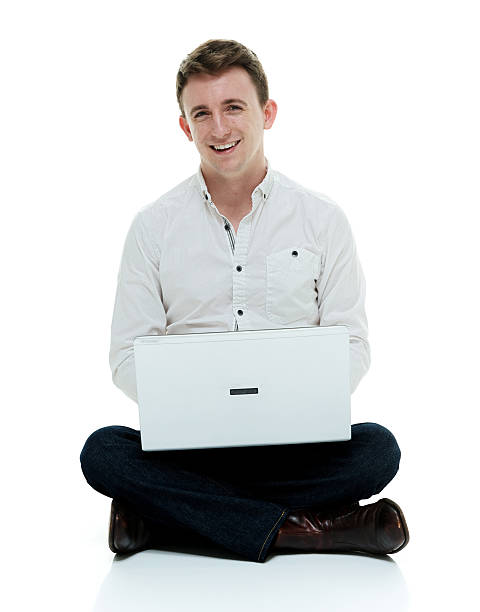 istock Smiling man sitting and working on laptop 500330852