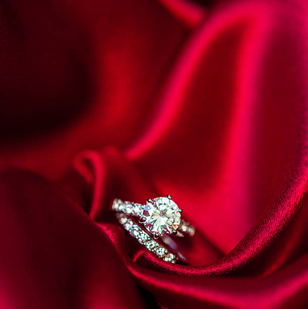 istock Wedding and engagement rings in rich red satin 500331746