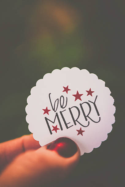 istock Handmade holiday message held against defocused Christmas tree 500332674