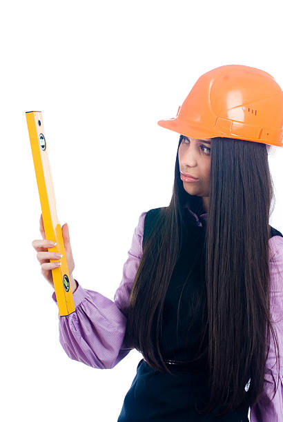 istock Attractive girl in helmet with level 500337060