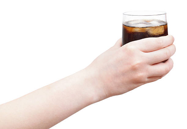 istock hand holding soft drink with ice in glass 500340085