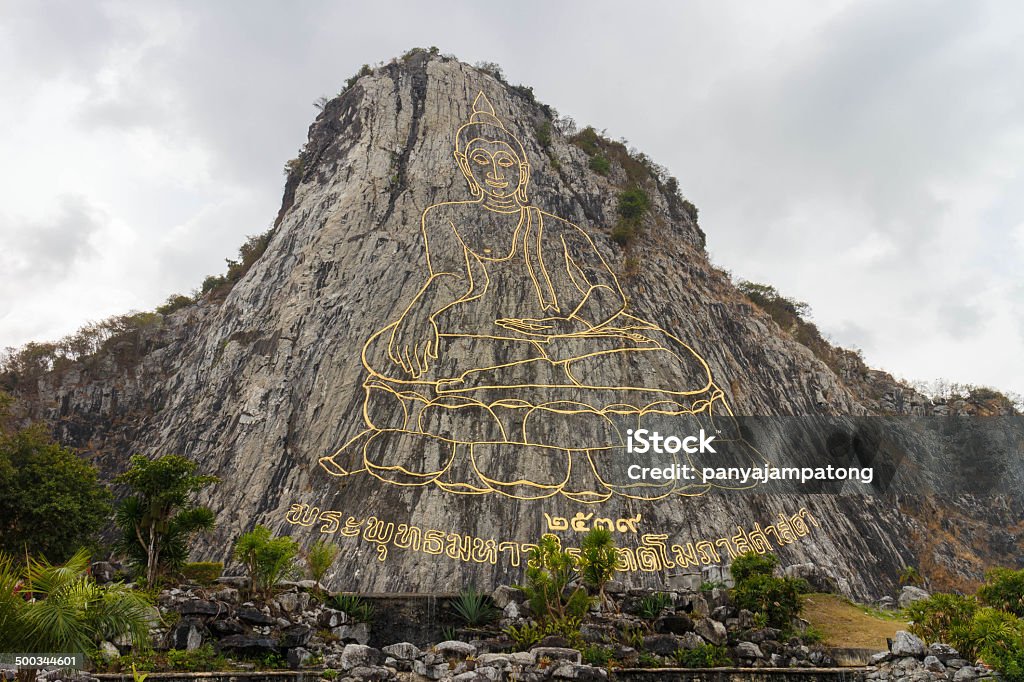 Carved buddha image on the cliff Carved buddha image on the cliff at Khao Chee Jan, Pattaya, Thailand Asia Stock Photo