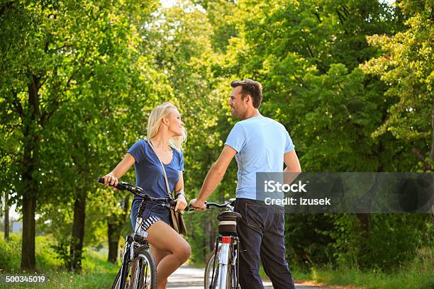 Happy Couple In A Park Stock Photo - Download Image Now - Bicycle, Cycling, Adult
