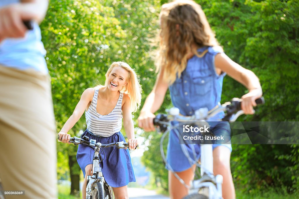 Family cycling Happy family cycling on a bicycles in a park. Focus on the mother. Bicycle Stock Photo