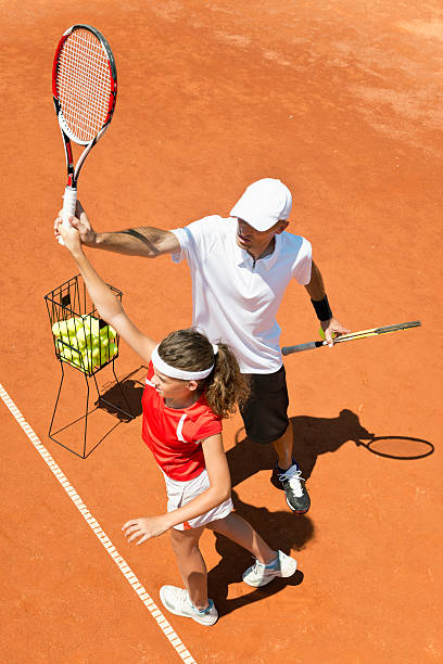 istock Coach with junior female tennis player 500345449