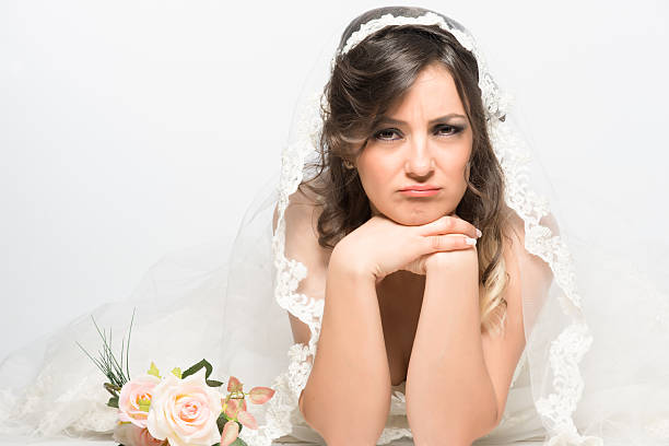 istock Sad and disappointed bride lying on the floor 500346277