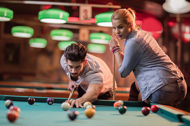 istock Young couple enjoying while playing snooker in a pub. 500359058