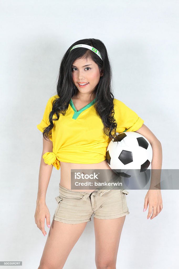 Portrait Beautiful woman hold ball with wearing Brazil football Portrait Beautiful woman  with wearing Brazil football top Adult Stock Photo