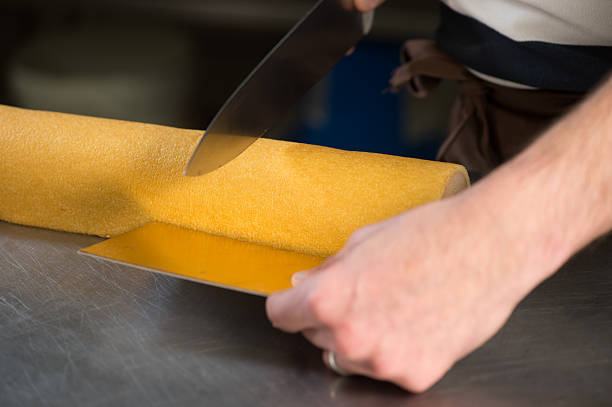 istock Pastry in his workshop preparing Chocolate Yule logs 500359356