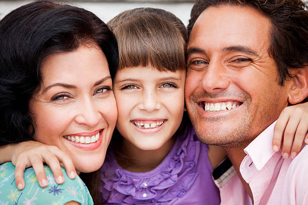 istock cheerful latin couple huggin daughter 500361773