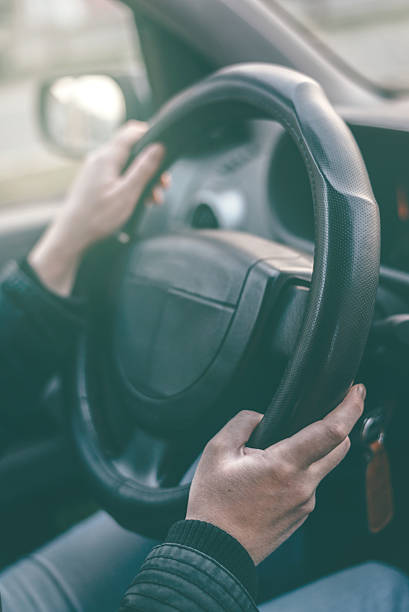 istock Female driver hands griping steering wheel 500361840