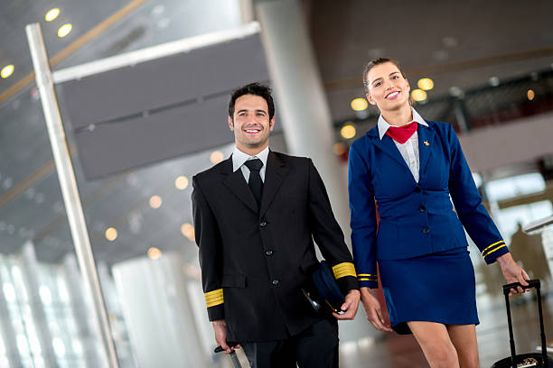 客室乗務員には、空港 - cabin crew pilot airport walking ストックフォトと画像