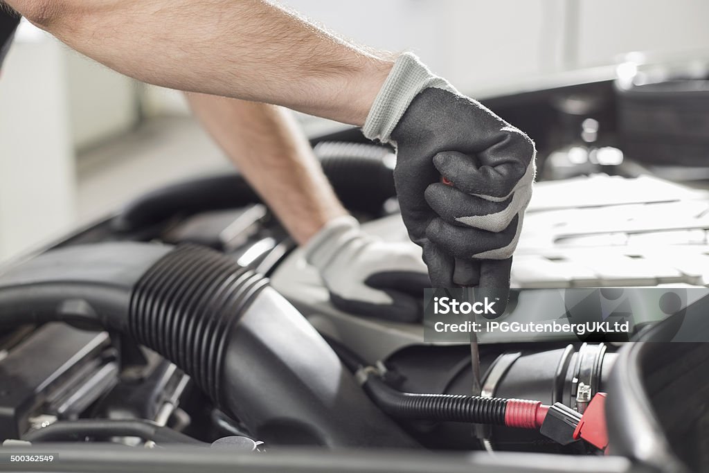 Cropped image of automobile mechanic repairing car Cropped image of automobile mechanic repairing car in automobile store 20-24 Years Stock Photo