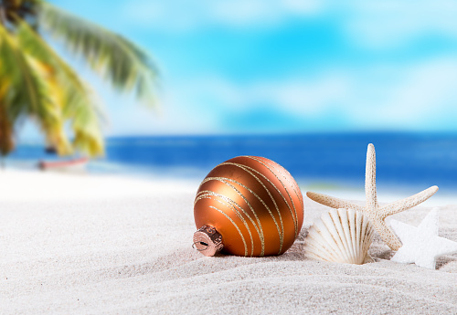 Christmas ornament on a beach,concept of a warm, tropical weather Christmas