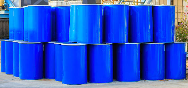 istock Two rows of big blue barrels 500364758