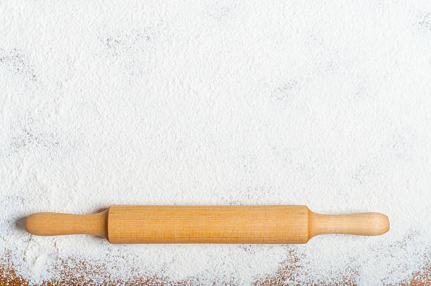 istock Sifted flour and rolling pin on the table. Kitchen background 500366536