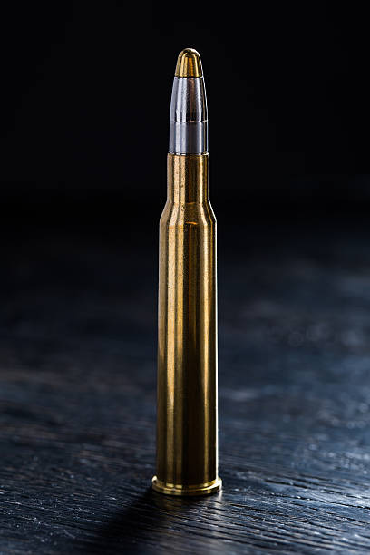 istock Large-caliber cartridge on a dark background 500367144